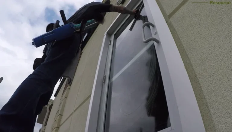 Professional window cleaner San Clemente CA working on two-story home exterior