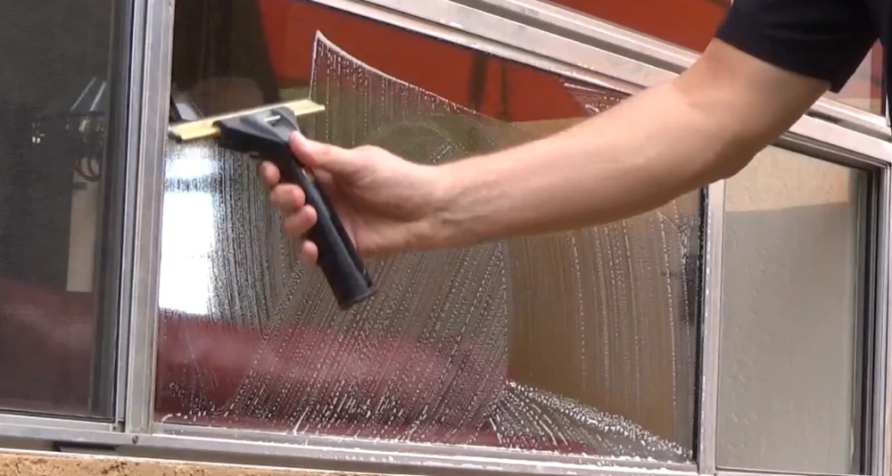 Window cleaner San Clemente CA removing salt film and hard water deposits from residential windows